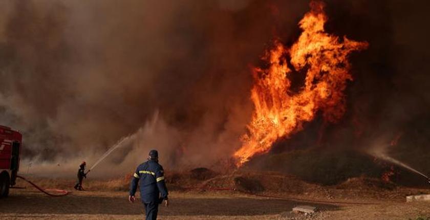 Los bomberos griegos luchan contra el quinto día de un gran incendio forestal al noroeste de Atenas